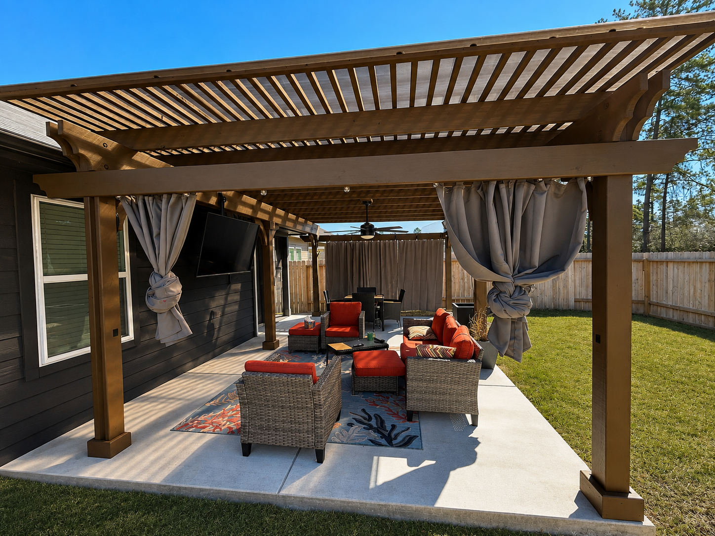 Wooden pergola with slatted roof over concrete patio with outdoor seating and curtains