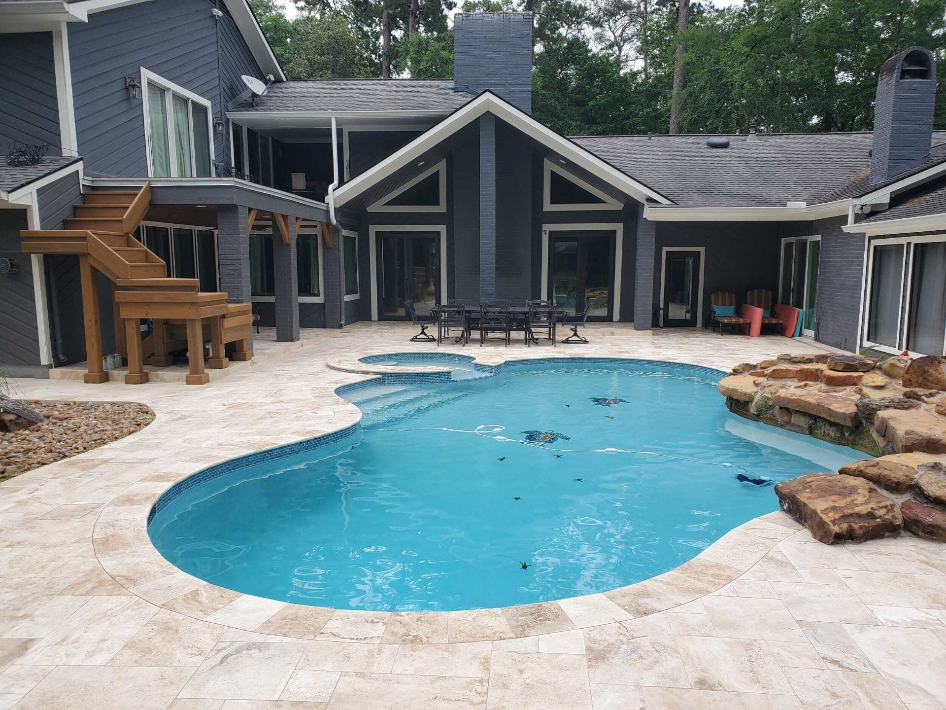 Lagoon-style freeform pool with rock waterfall