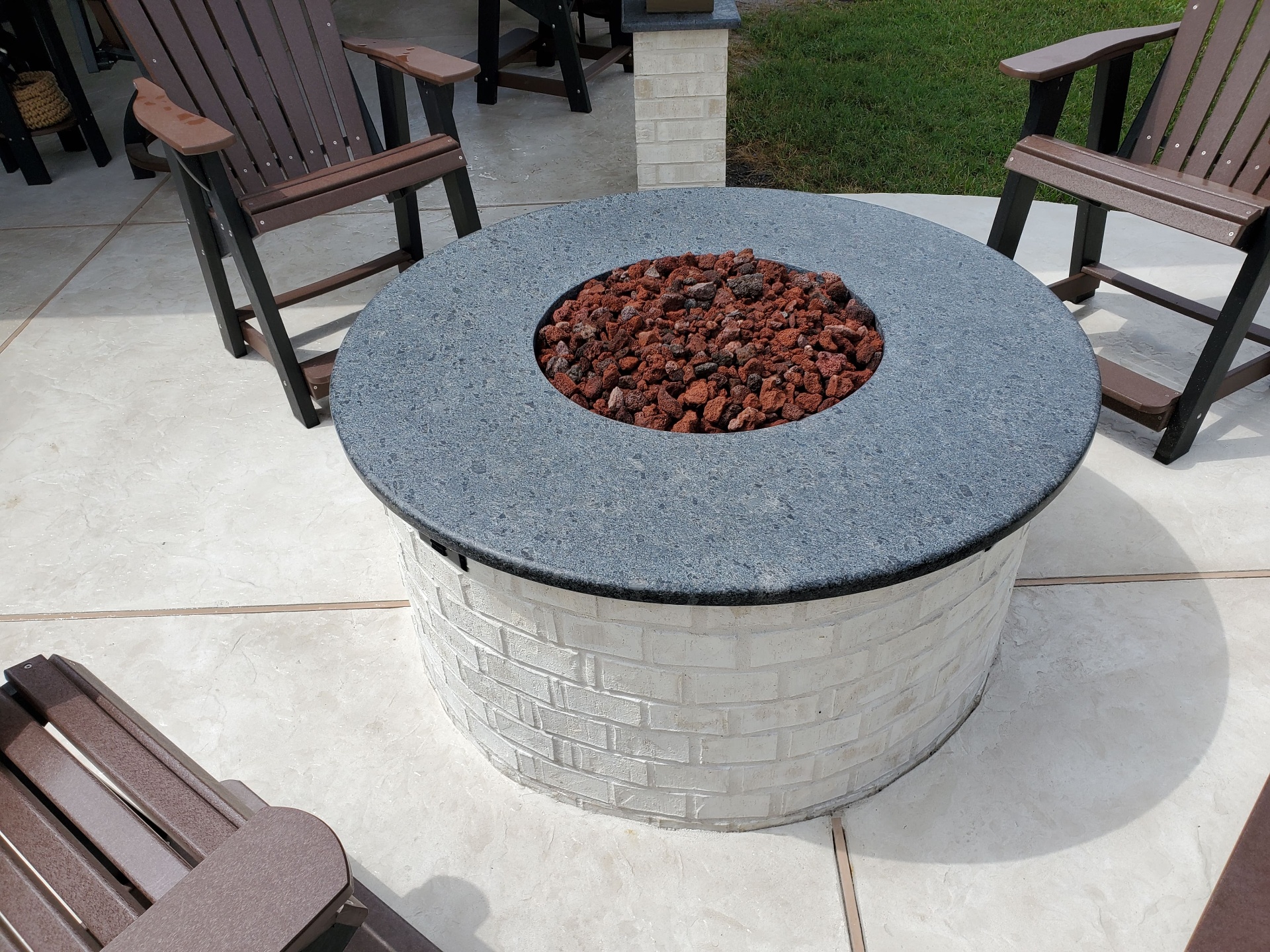 Outdoor stone fireplace on covered patio