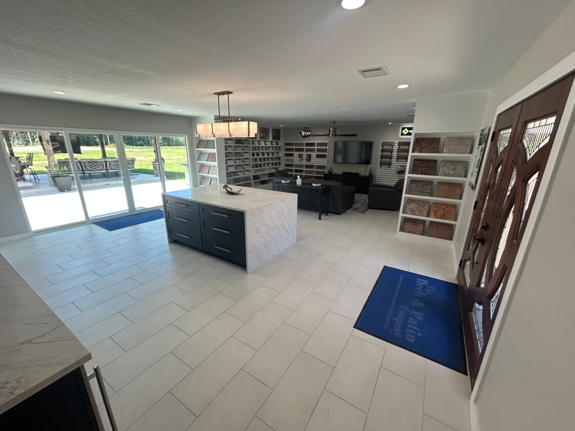 The Deck & Patio Company Design Center entry with marble island and material displays