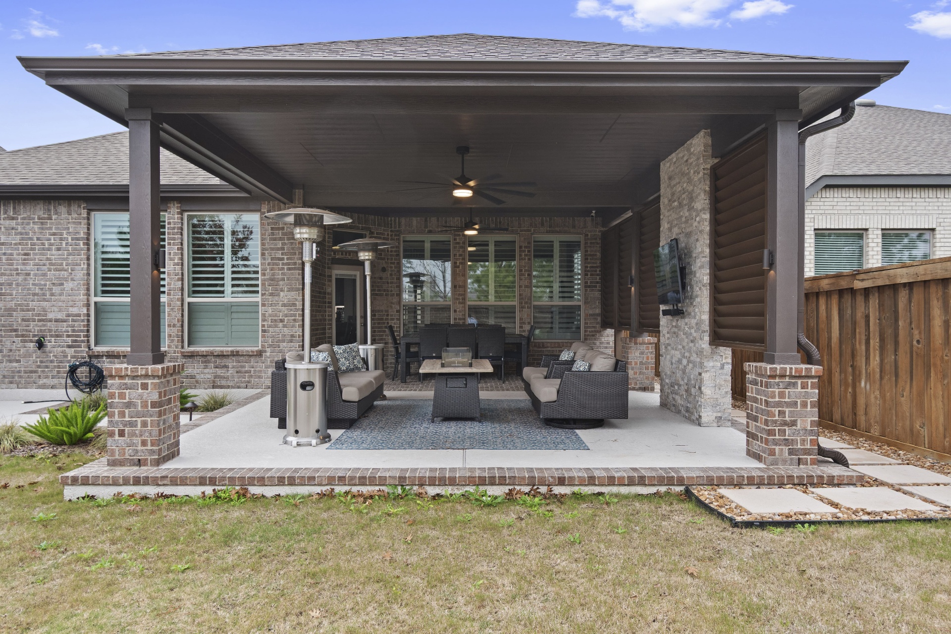 Modern covered patio with brick columns and stone accents