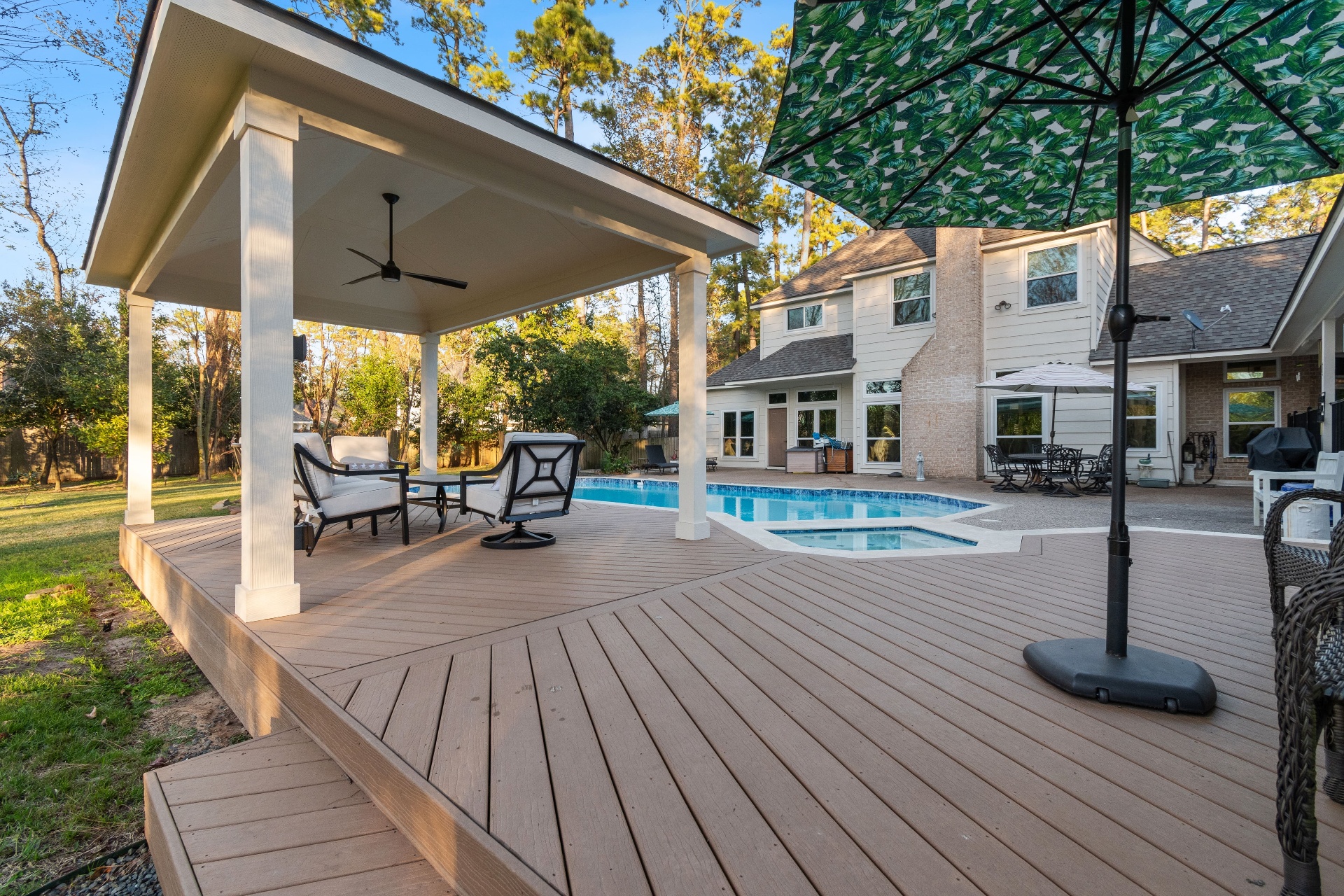 Custom covered patio next to a pool