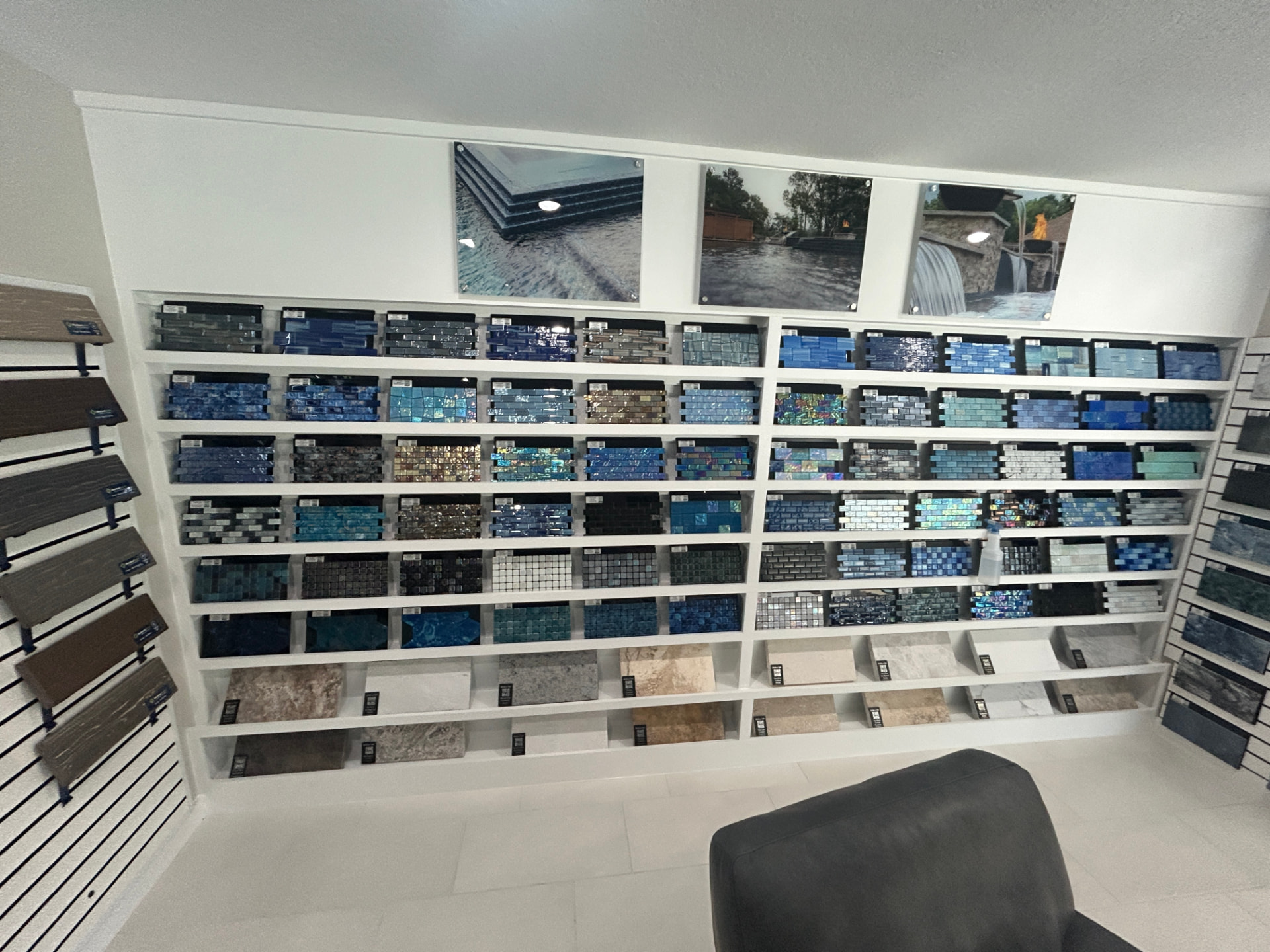 Wall of glass waterline pool tile and stone samples at the Design Center
