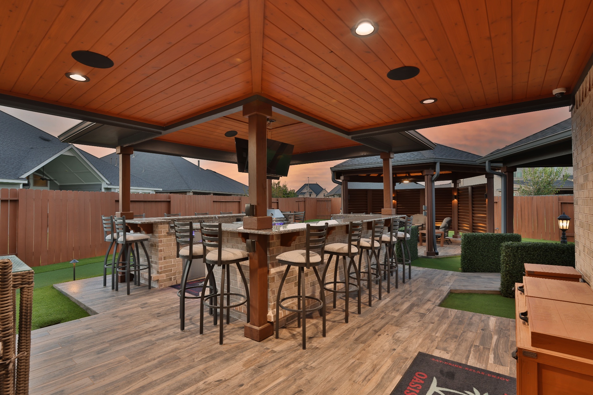 Covered outdoor bar and kitchen with sunset backdrop