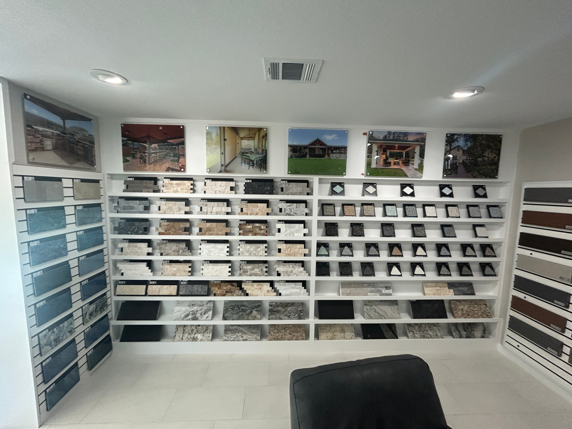 Ledger stone, travertine, and granite countertop samples on display shelving