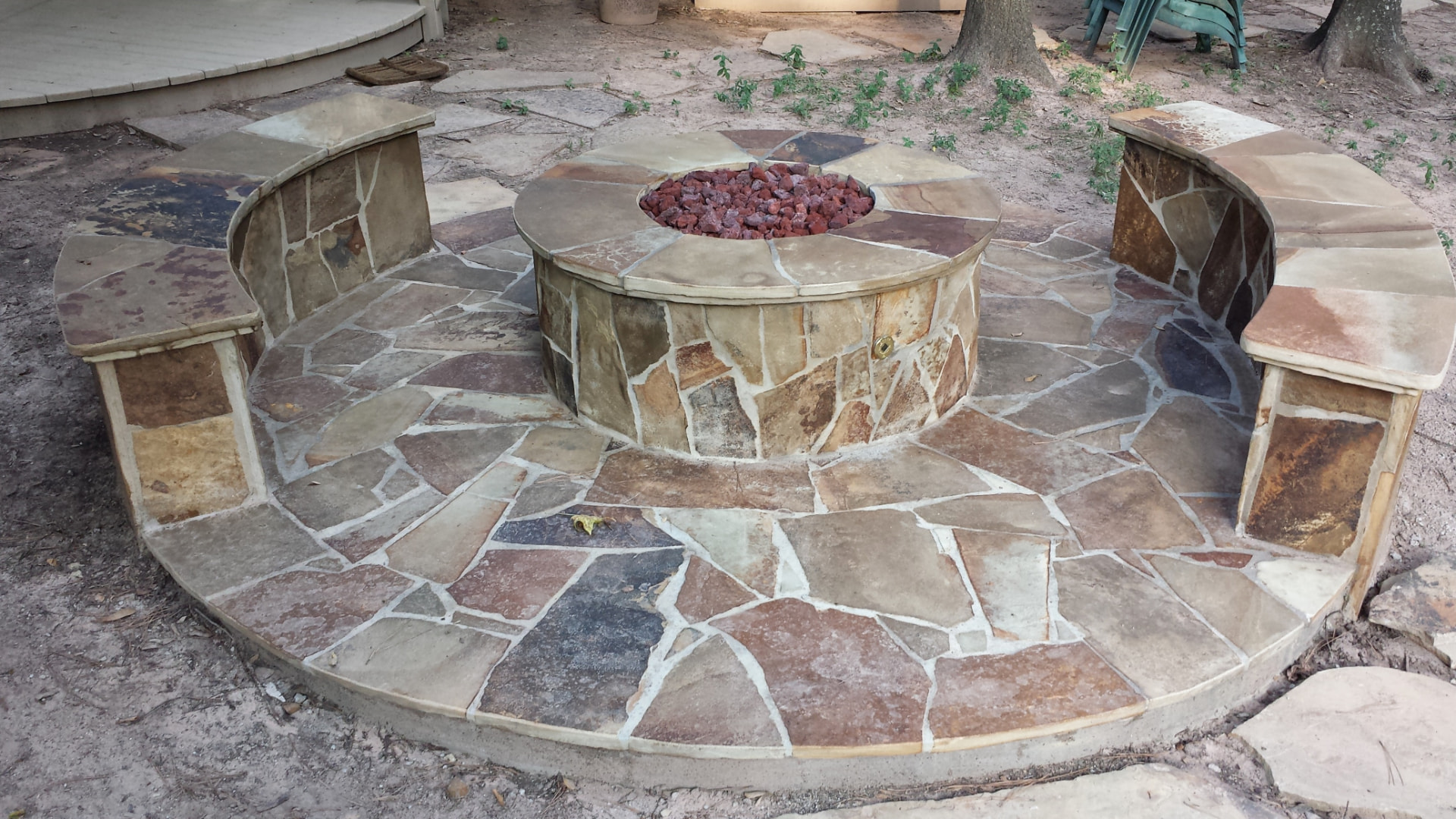 Flagstone fire pit with matching flagstone patio and curved stone benches