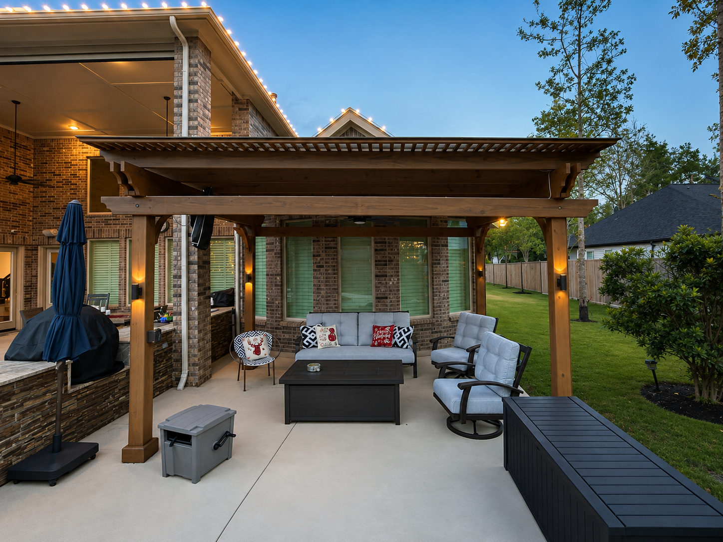 Backyard pergola with string lights, outdoor seating, and fire pit table at dusk