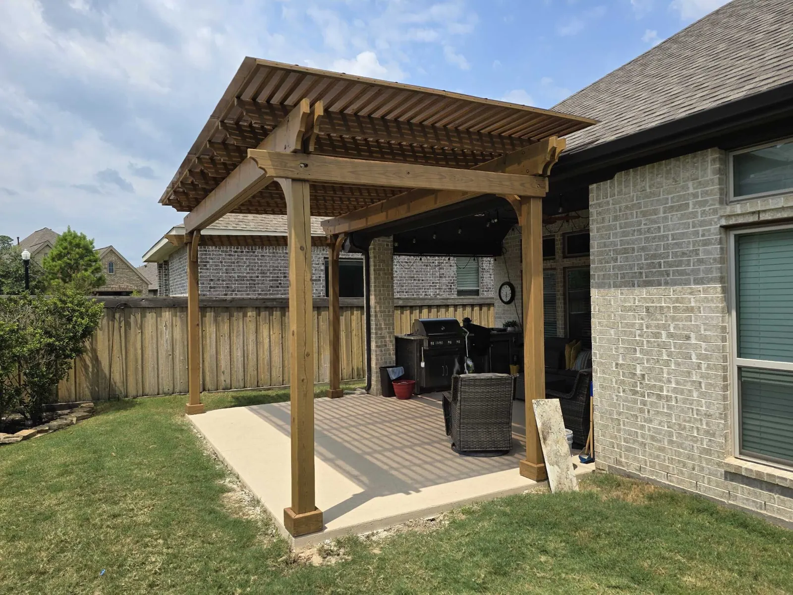 Attached pergola shade structure over concrete patio