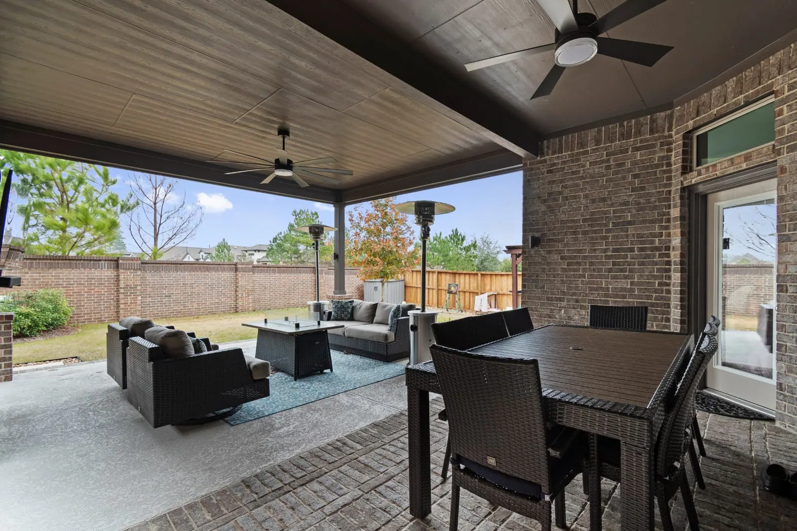 Covered patio with outdoor dining, fire table and lounge seating
