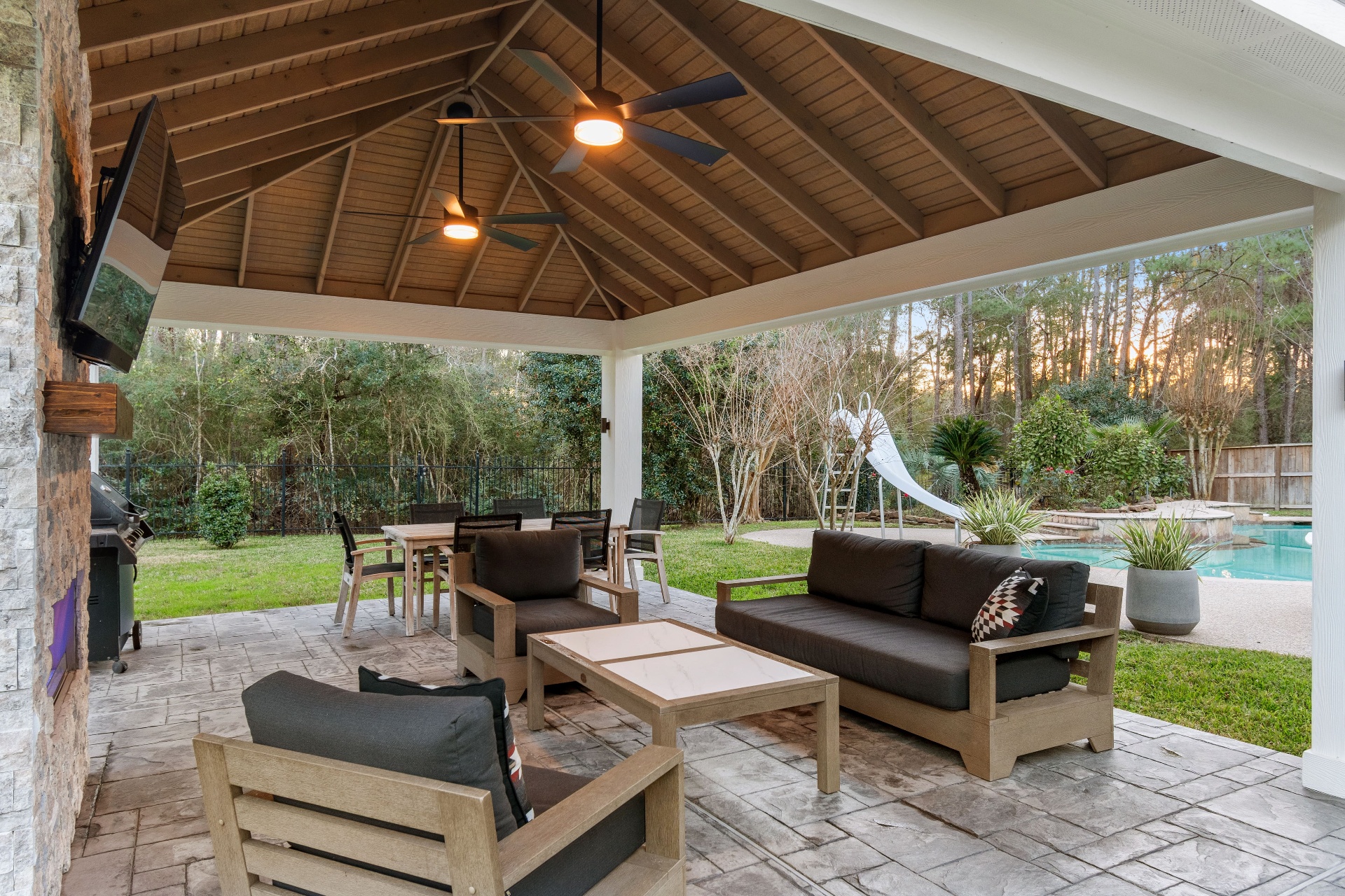 Vaulted covered patio with pool view and outdoor seating