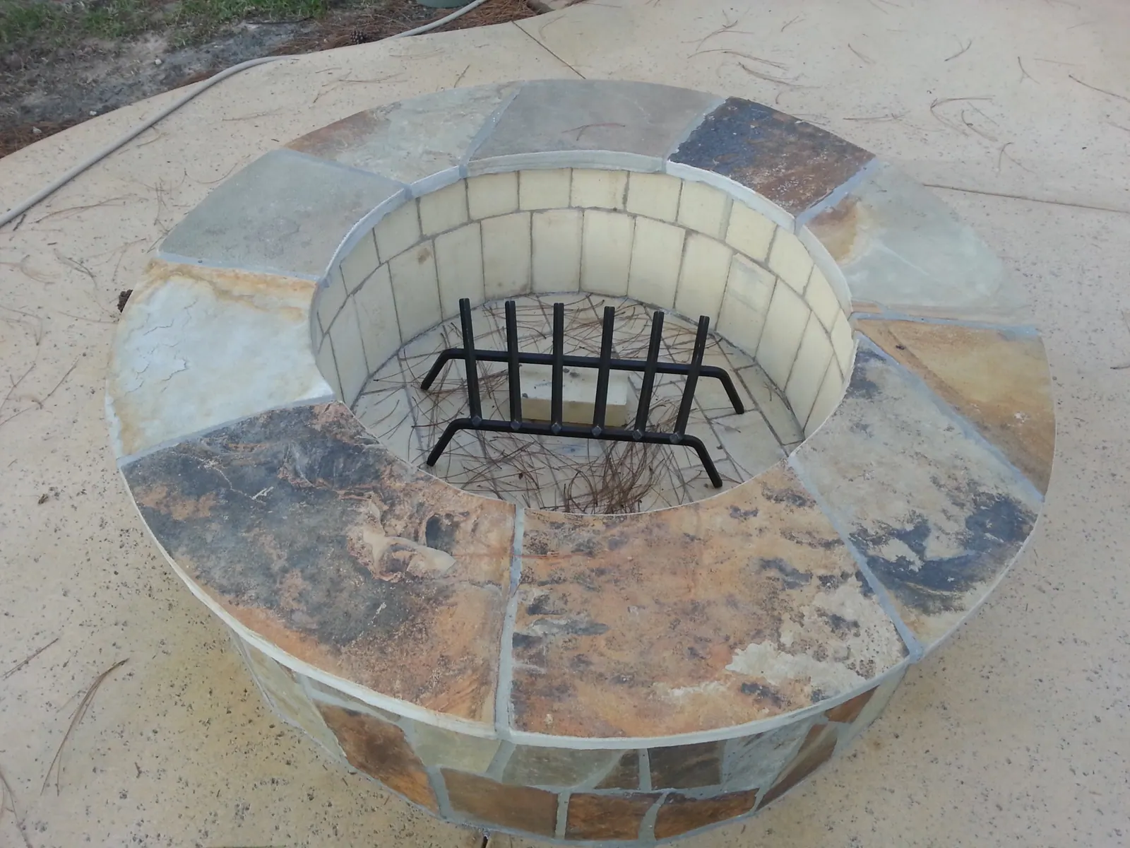 Round flagstone wood-burning fire pit with firebrick interior