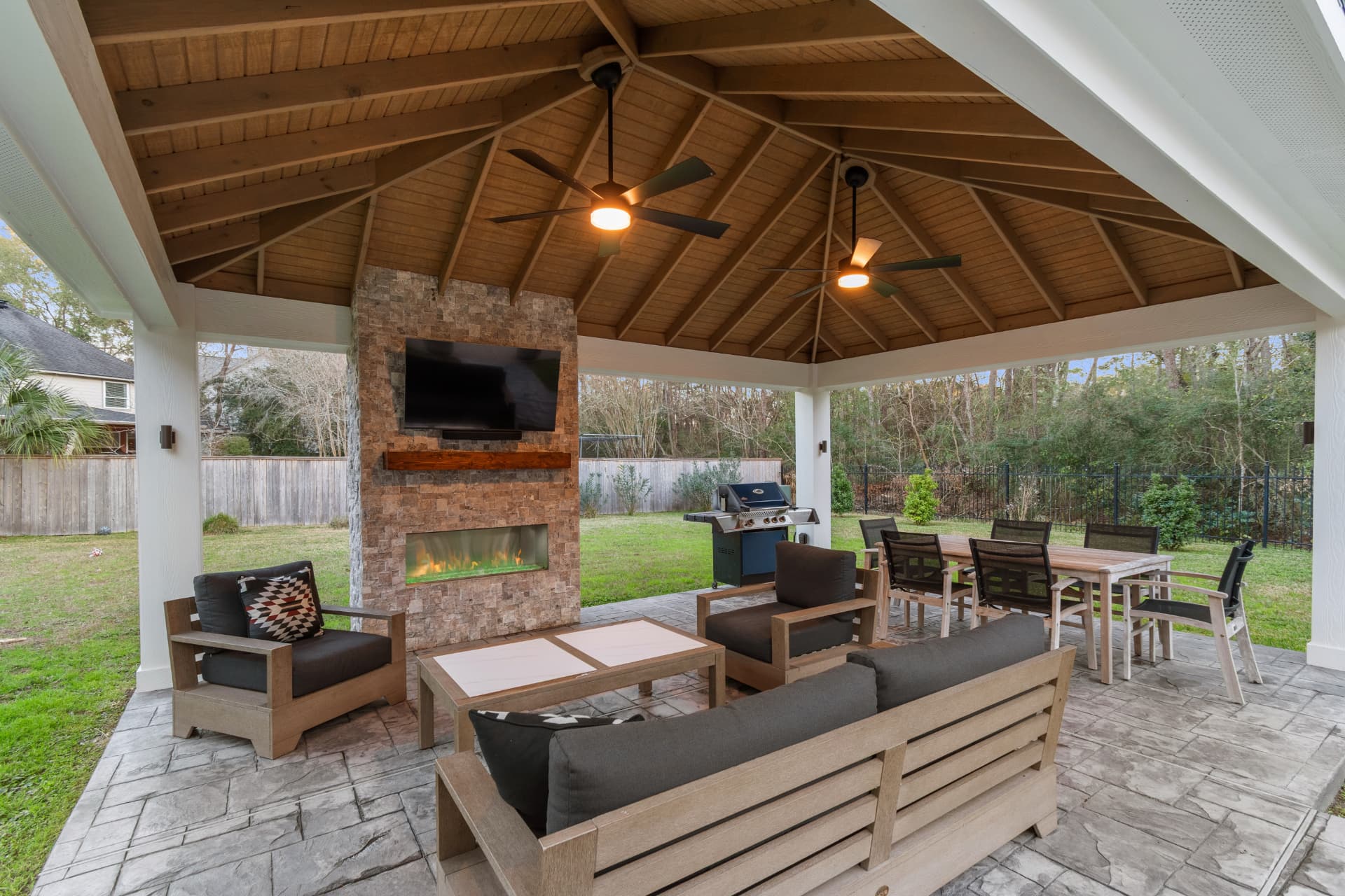 Freestanding pavilion with stone fireplace, TV wall and vaulted cedar ceiling