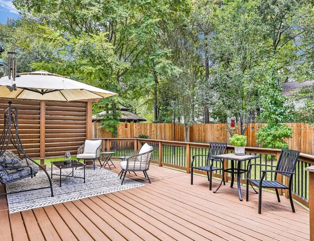 Well-maintained wood deck with outdoor seating
