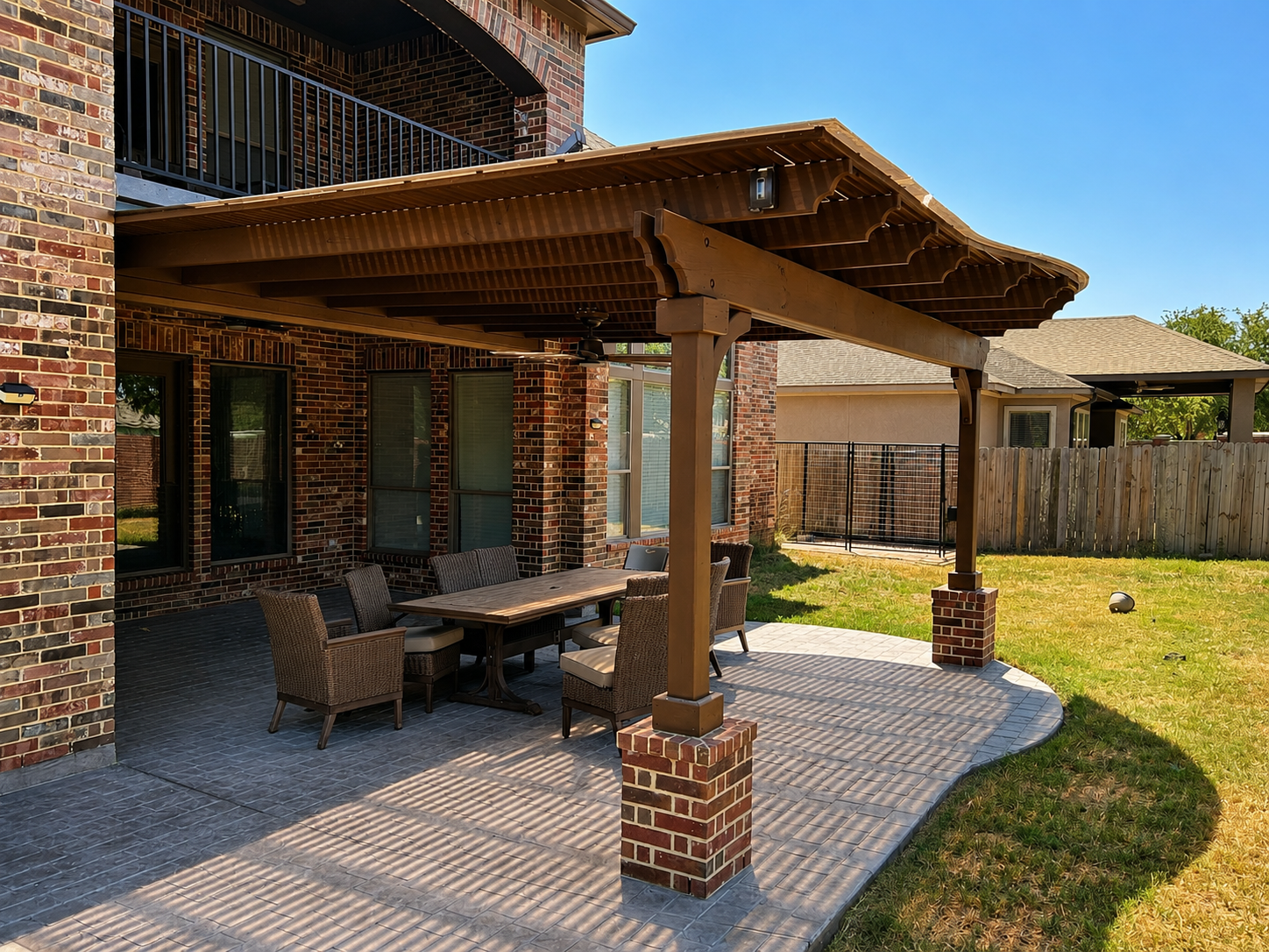 Custom pergola with brick-wrapped posts over a paver patio with dining set