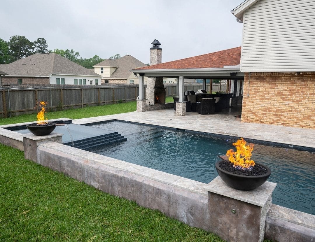 Custom Houston pool with fire bowls and covered patio
