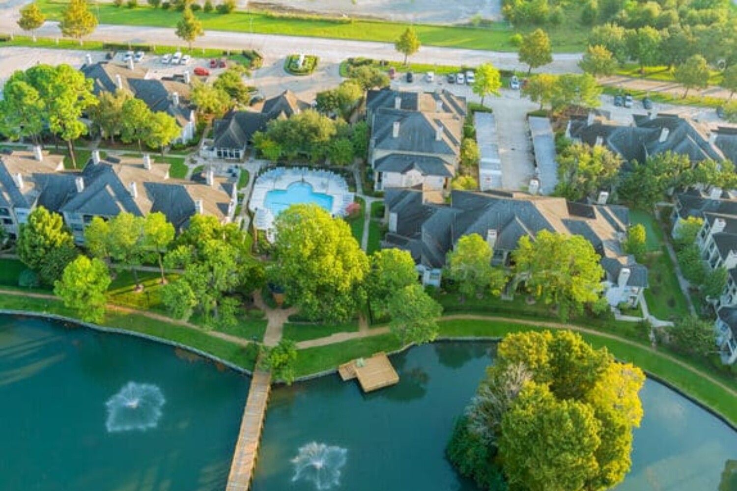 Aerial view of residential houses and driveways neighborhood during a fall sunset in Houston, Texas, US