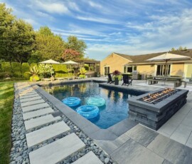 Chair, sofa, couch, bar and table. Hotel resort feel. Watch television, dine, have a drink or cocktail by the bar. Luxurious high end at home sanctuary, prime real estate. Modern indoor outdoor living entertainment space and patio under a pavilion pergola. poolside equipped with bar and gas fire pit with cascading waterfall. Luxury living.